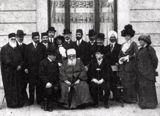 'Abdu'l-Bahá in Budapest with His companions, hosts and journalists in front of Hotel Ritz (Published in Érdekes Újság, 10 April 1913)